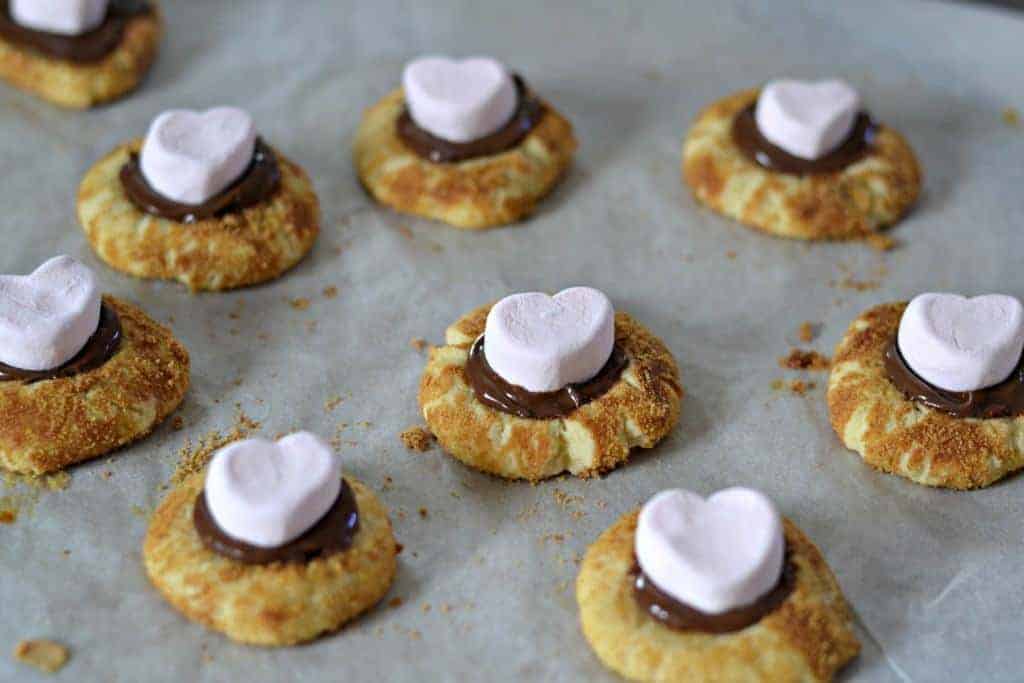 Use cute pink heart-shaped marshmallows for a sweet Valentine's Day treat. Pink Heart marshmallows on cookies