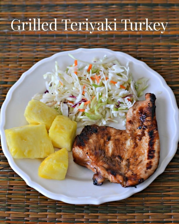 Grilled Teriyaki Turkey on a plate with coleslaw and pineapple chunks