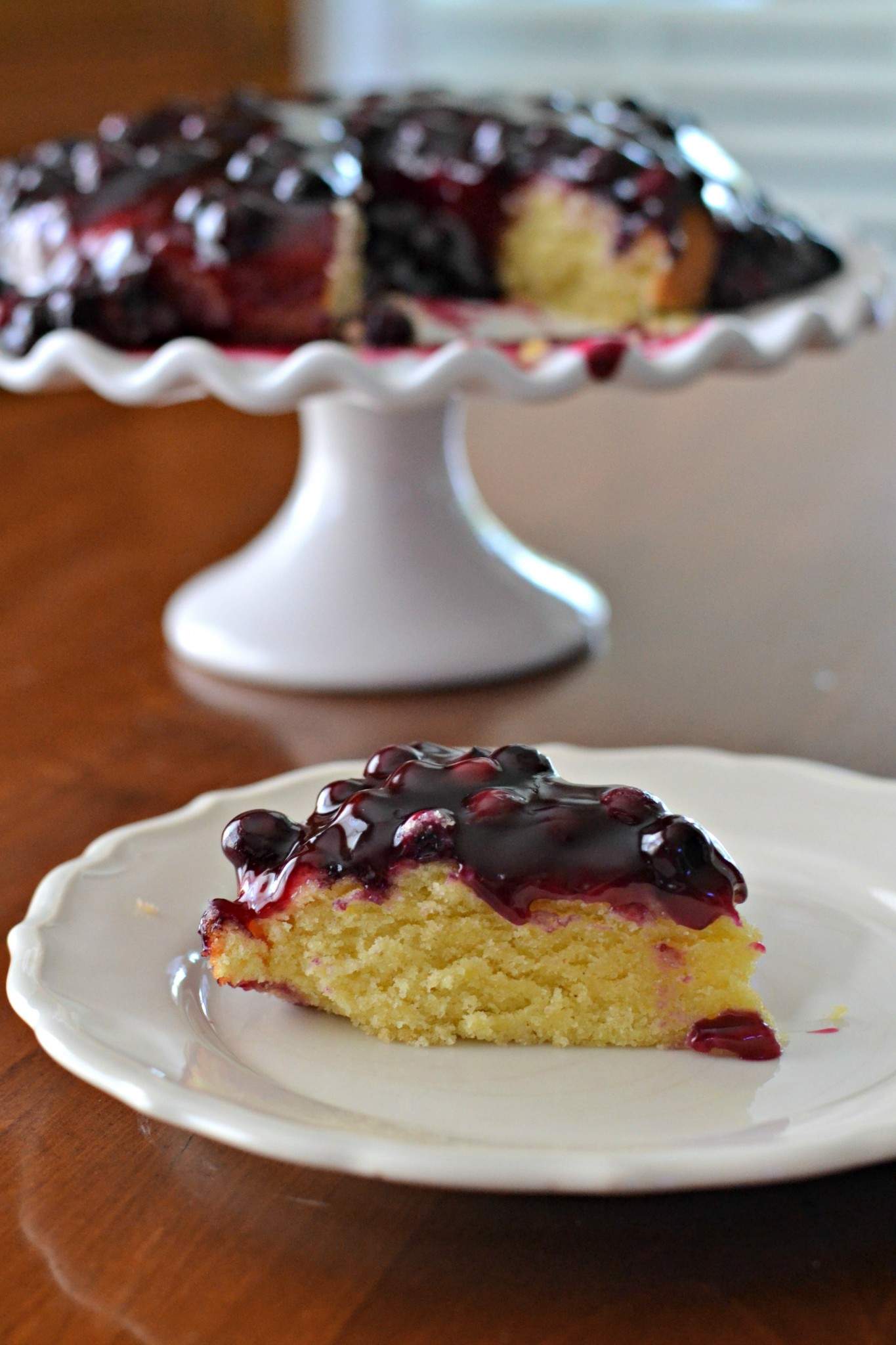 Blueberry Lemon Cake on a pedestal.