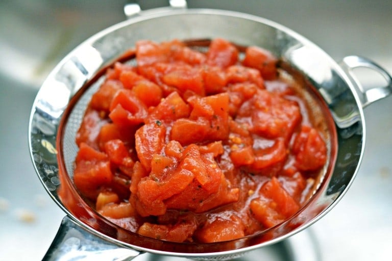tomatoes draining in a strainer