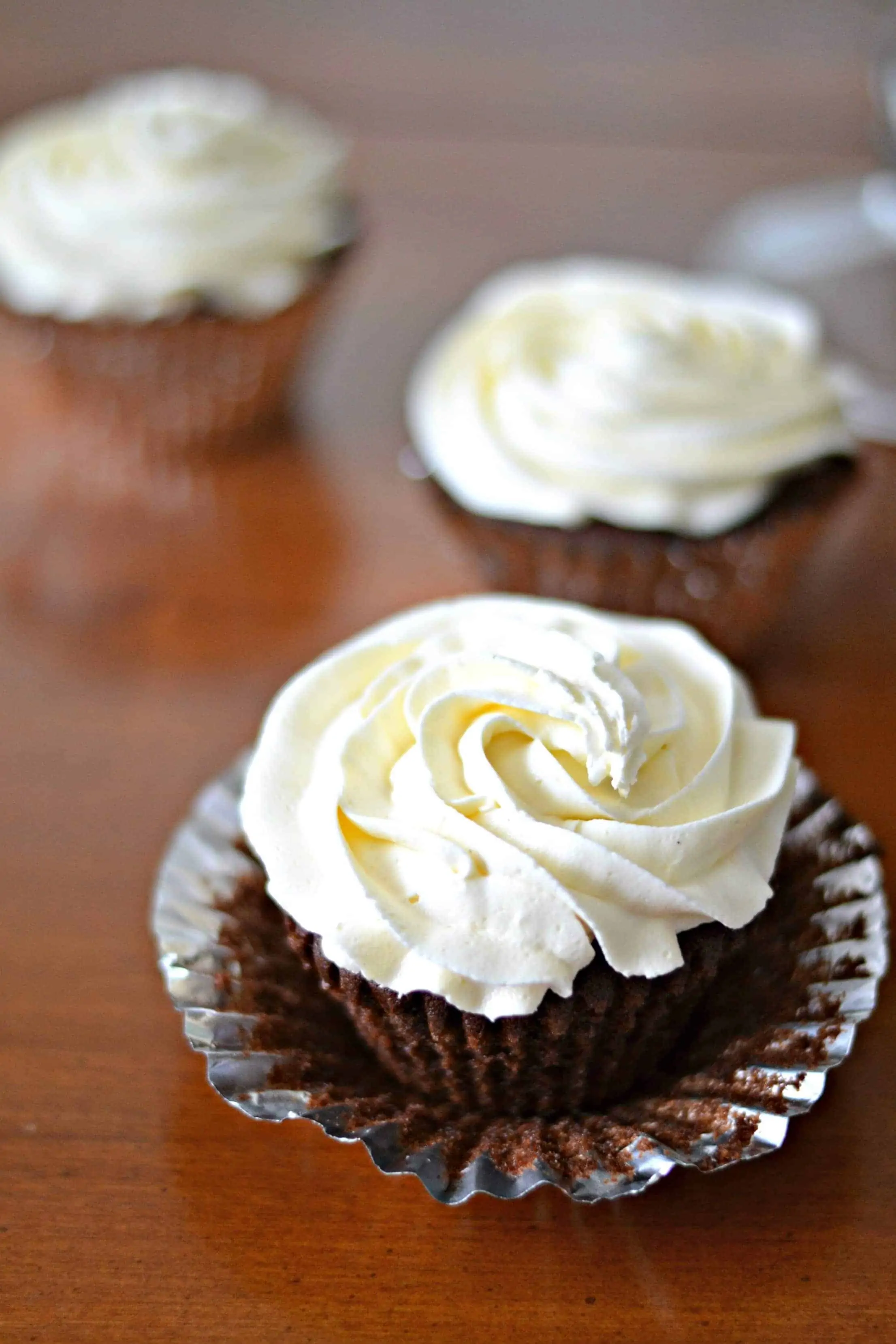 Homemade Vanilla Buttercream Frosting Recipe vanilla icing on top of chocolate cupcakes