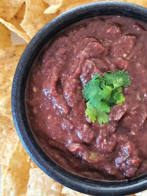 Delicious black bean dip - perfect for Cinco de Mayo and all of your favorite fiestas! bowl of black bean dip