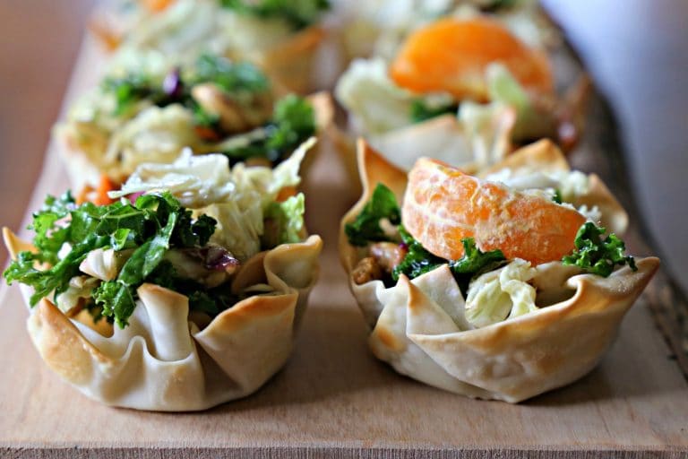 mini salad cups in wonton wrappers topped with orange slices