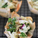 Mini Asian salad cups made with crispy wonton shells on a cooling rack.