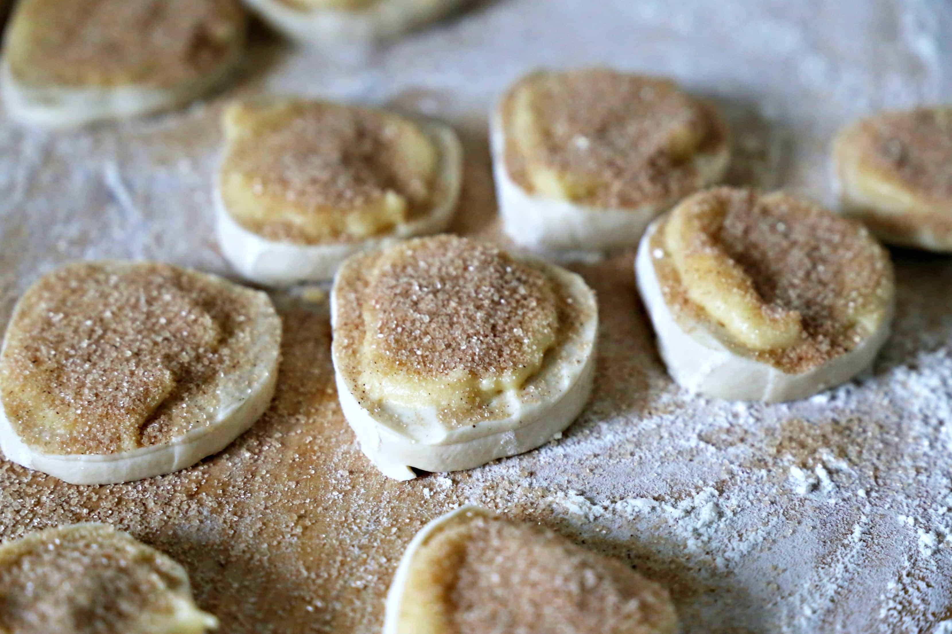 Bread dough rounds with butter and cinnamon sugar.