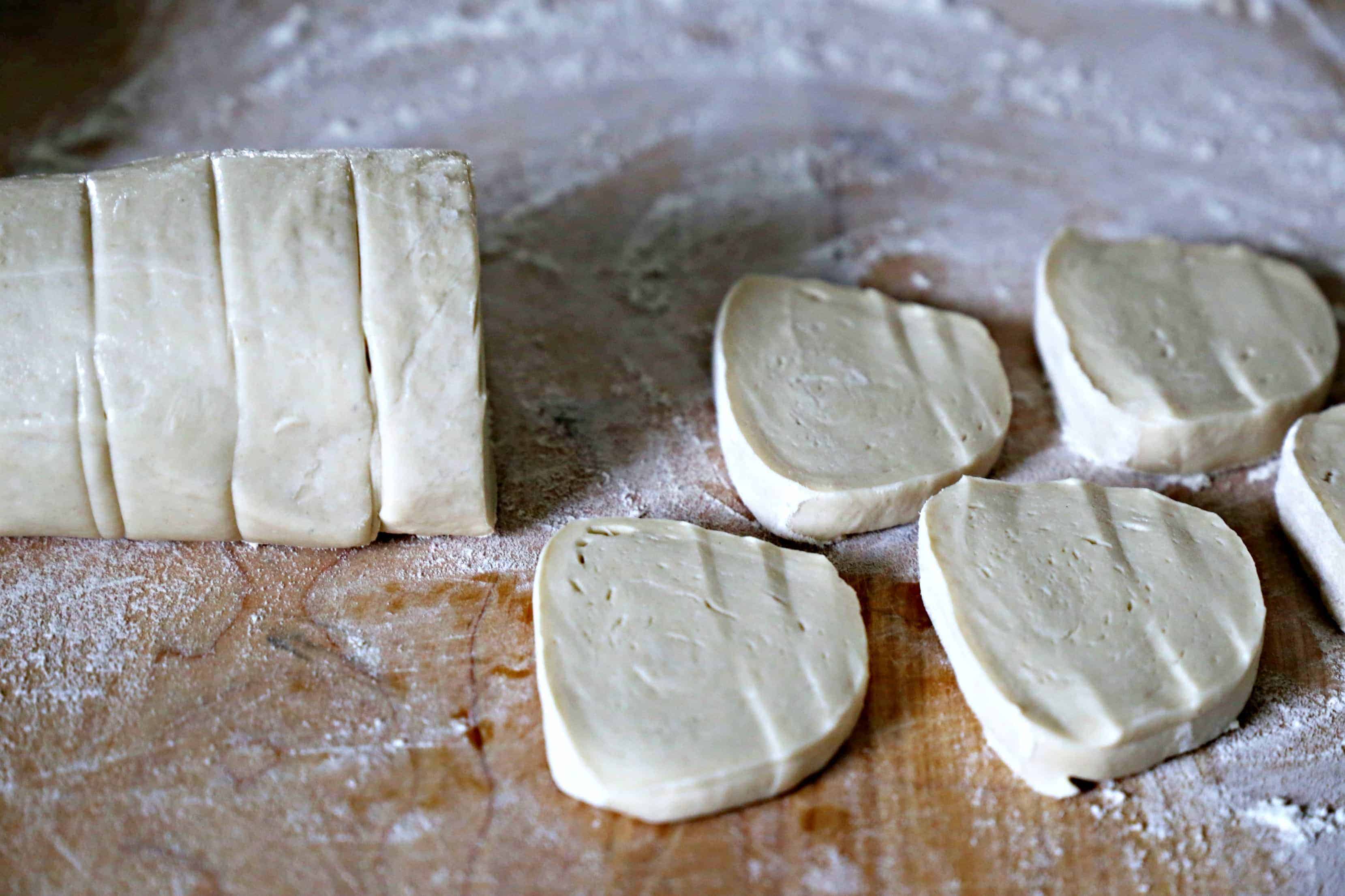 Slices of bread dough on a cutting board.