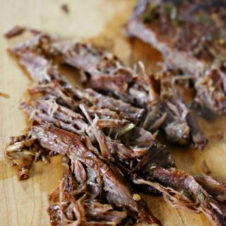 chopped carne asada on a cutting board
