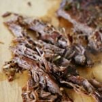 Chopped carne asada on a cutting board.