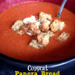 Bowl of tomato bisque topped with croutons.