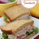 Tuna sandwich with lettuce and tomato.