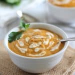Bowl of creamy tomato soup with swirls of cashew cream.
