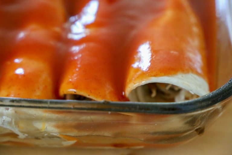 Roll the enchiladas and place them seam side down. enchiladas with red sauce