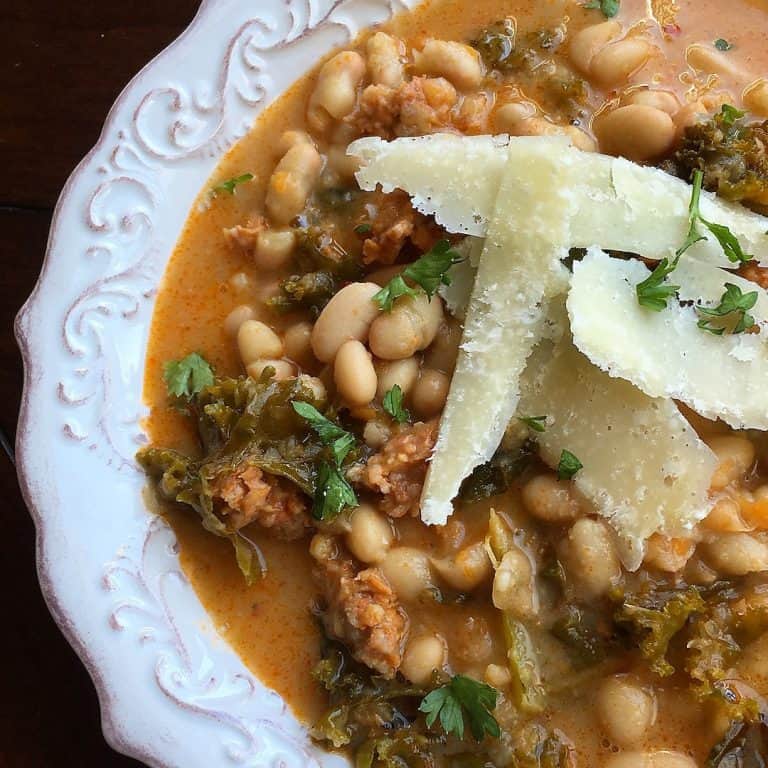 One-Skillet White Bean and Spicy Sausage Soup White Bean and Spicy Sausage Soup topped with Parmesan cheese