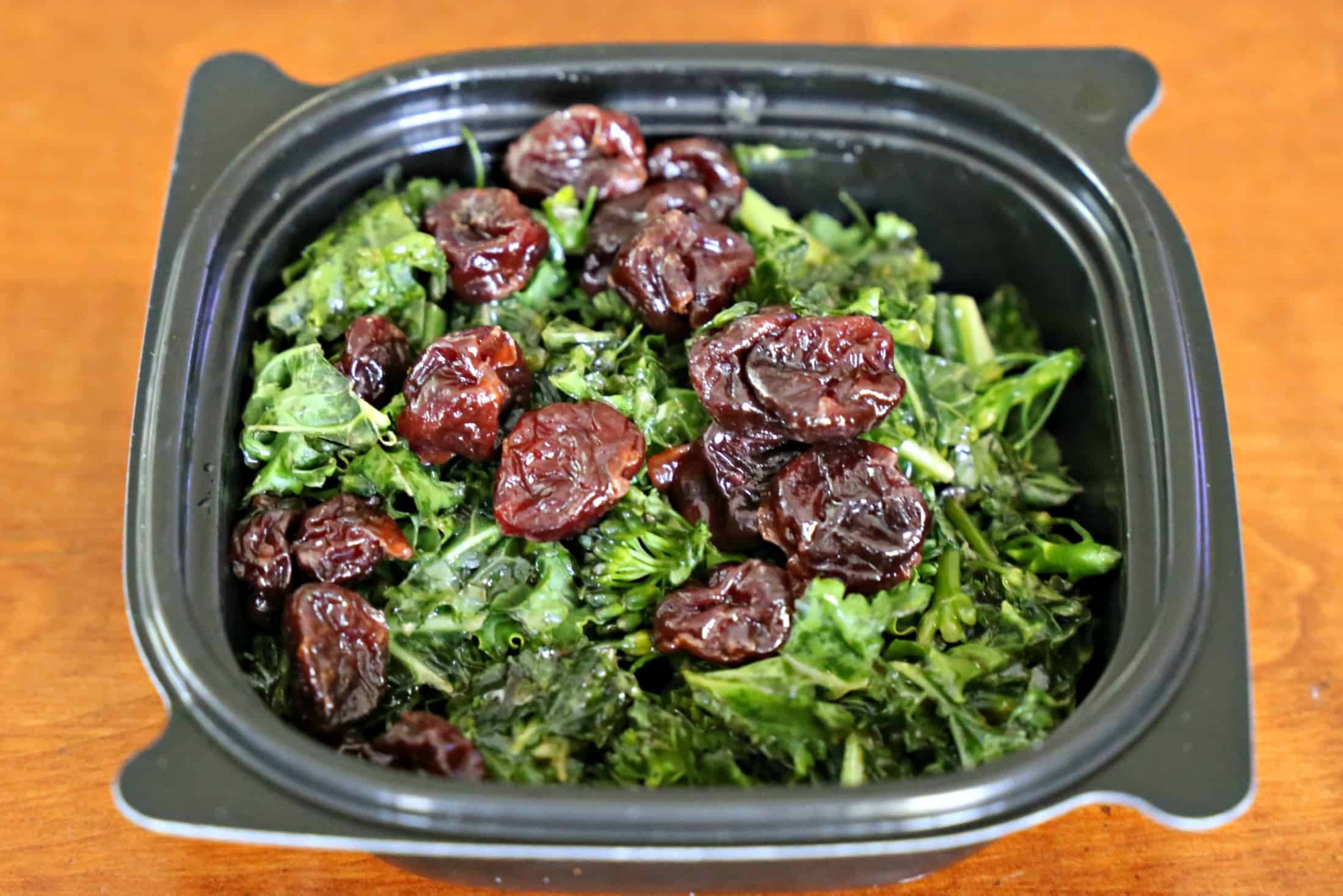 Superfood side made with kale and raisins in a small bowl.