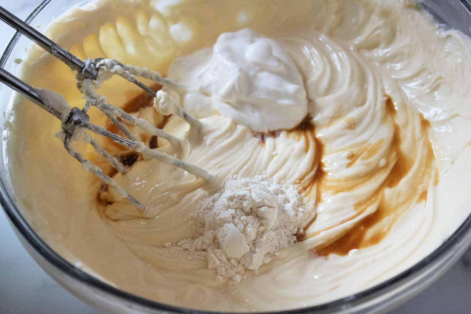 Adding sour cream to cream cheese mixture.