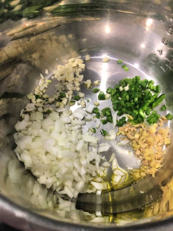 peppers and onion sauteeing in an Instant Pot