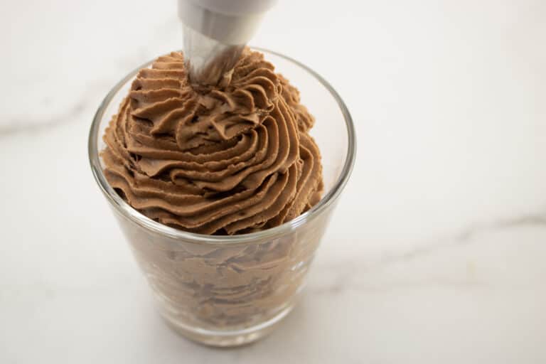 piping chocolate mousse into a glass