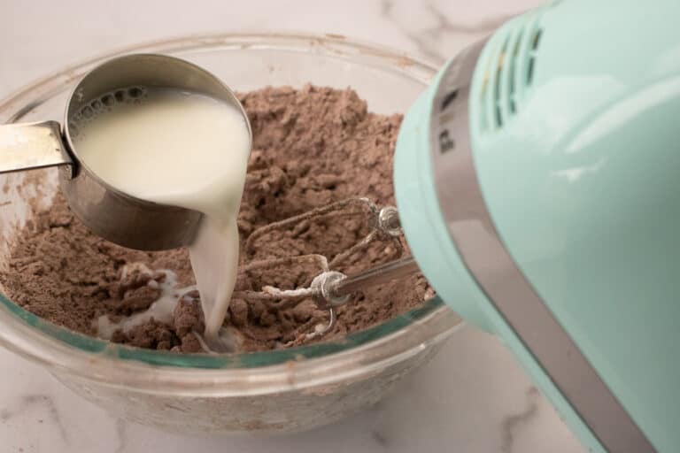 adding milk to sugar mixture