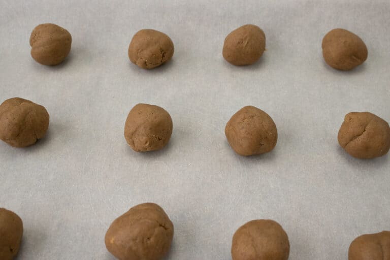 cookie dough balls on parchment paper