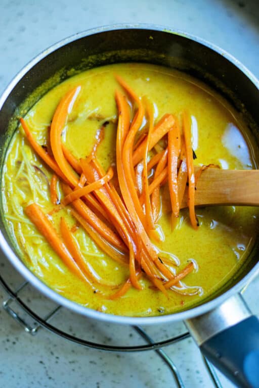 adding vegetables to the soup