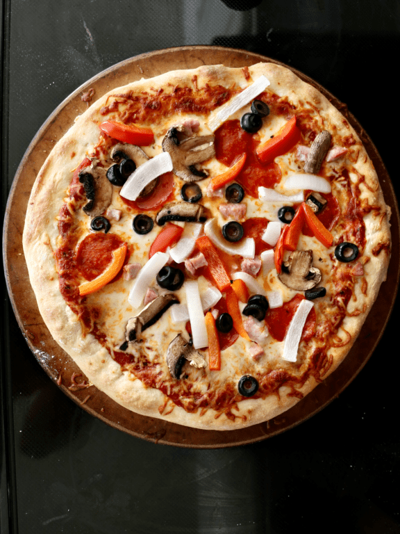 pizza with onions, bell peppers, olives, mushrooms, and pepperoni