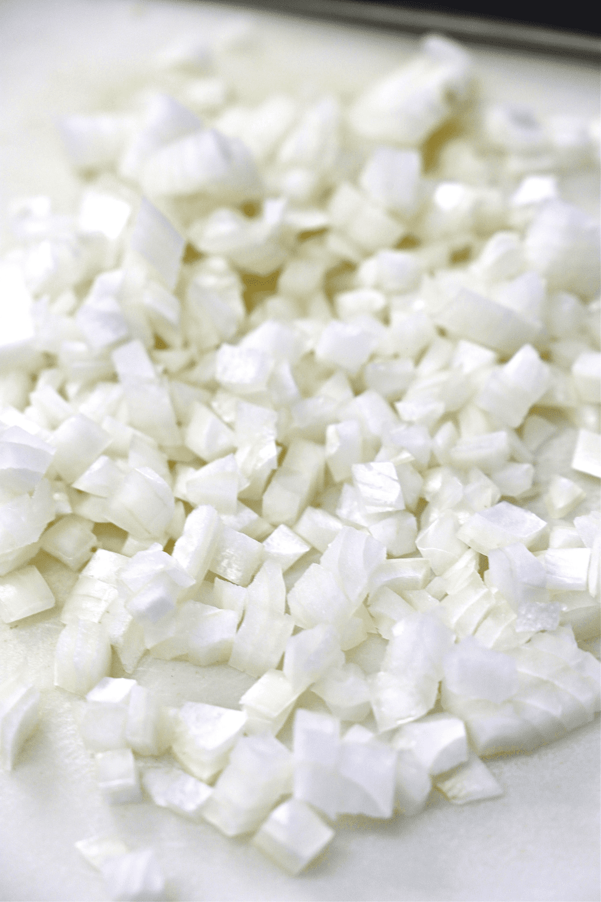 Diced onions on a cutting board.