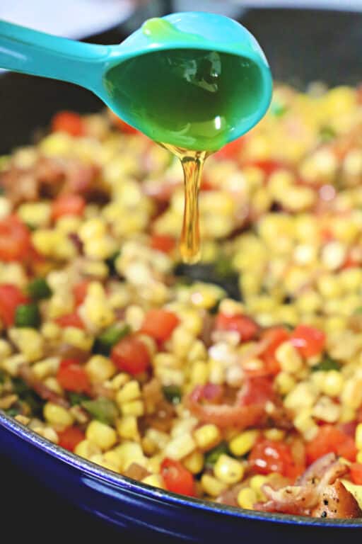 drizzling honey on corn