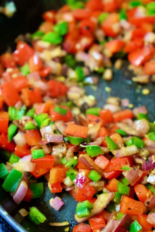 bell peppers and onions cooked in a skillet