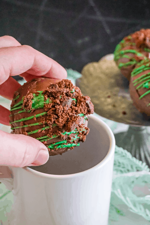 placing cocoa bomb in mug