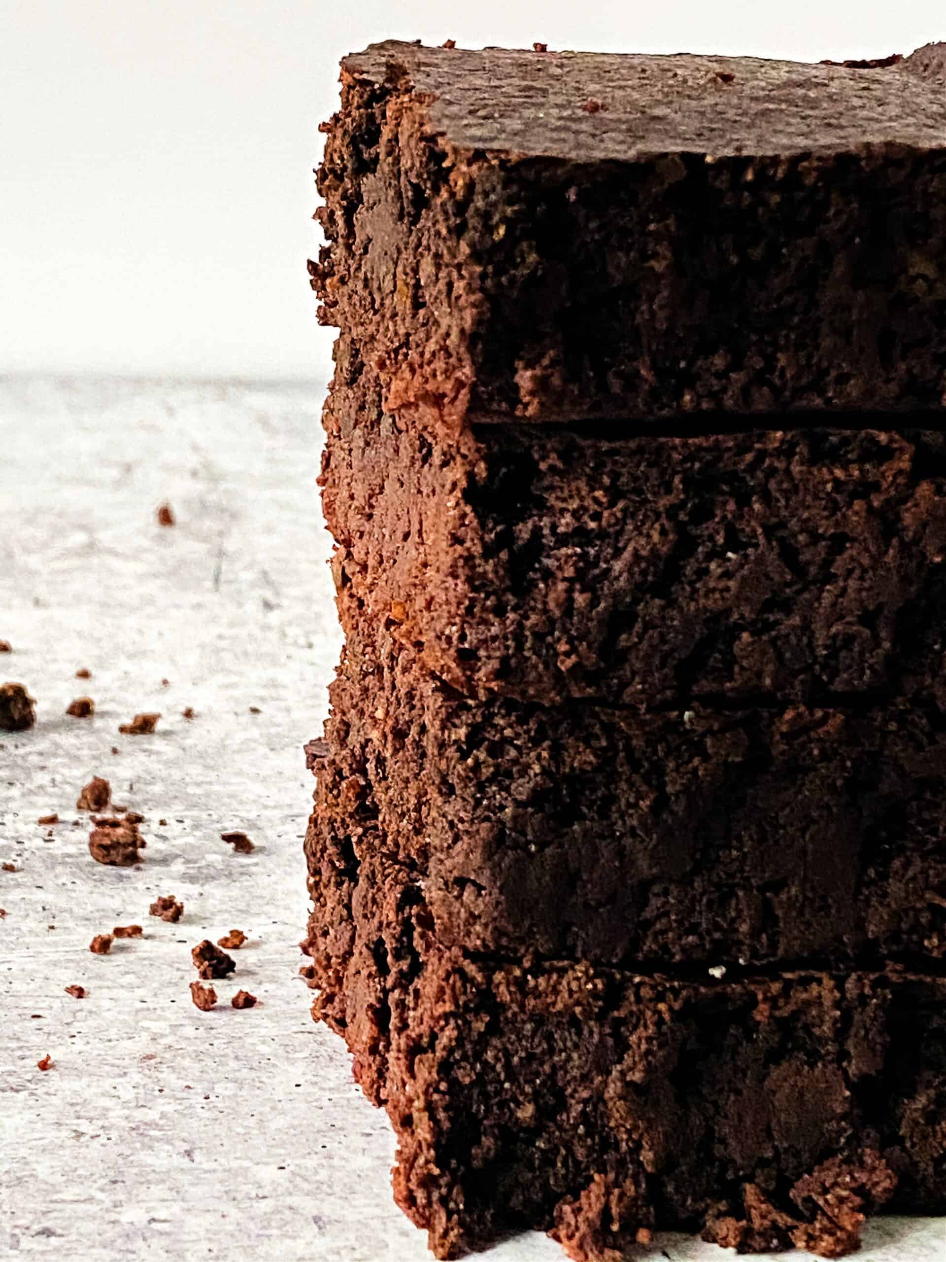 Stack of low-carb brownies on a counter.