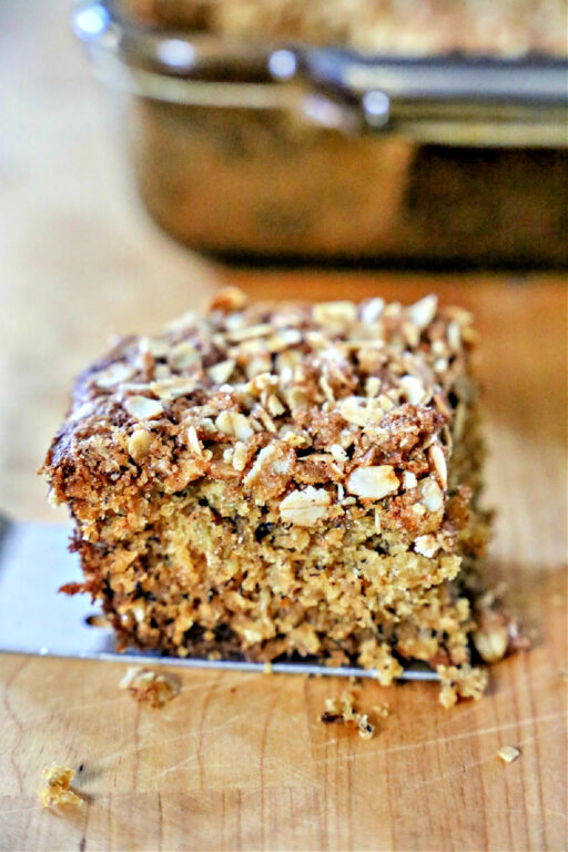 You might be tempted to eat this Banana Oatmeal Cake for breakfast. Banana Oatmeal Cake sitting on a cutting board.