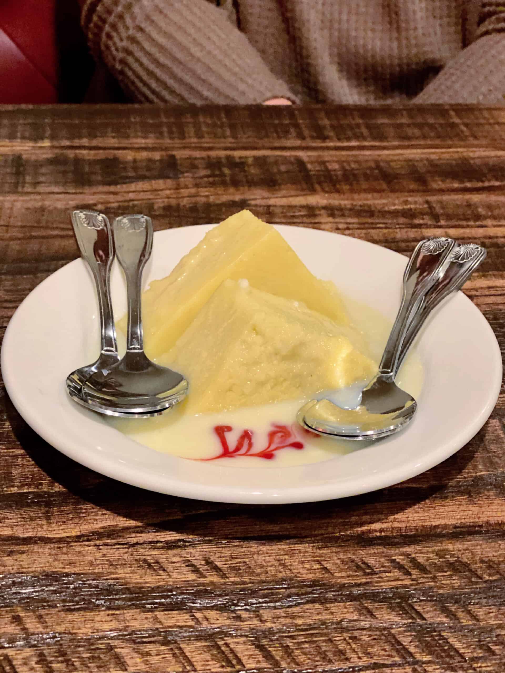 Bread Pudding on a plate with three spoons.