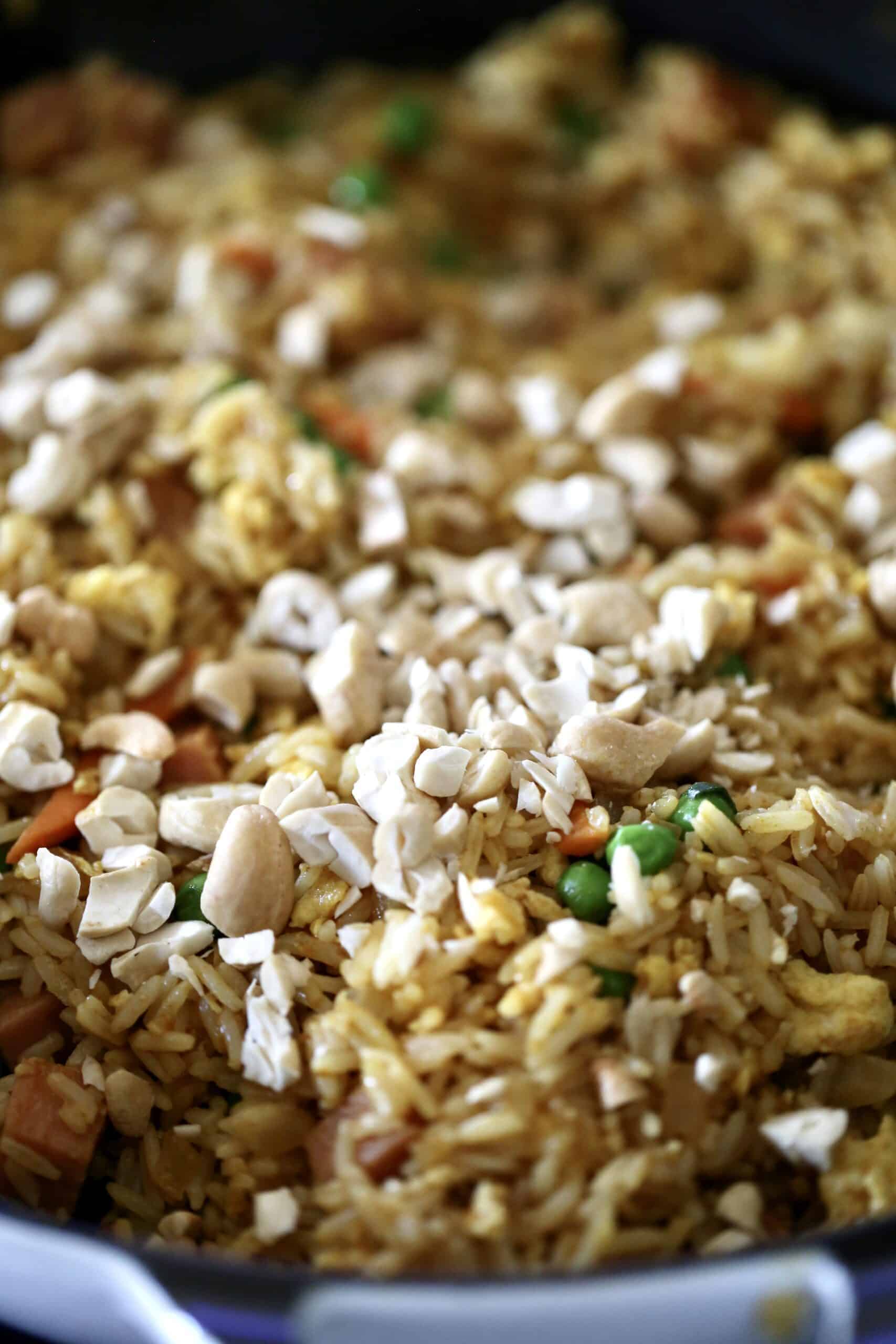 Chopped cashews on top of fried rice.