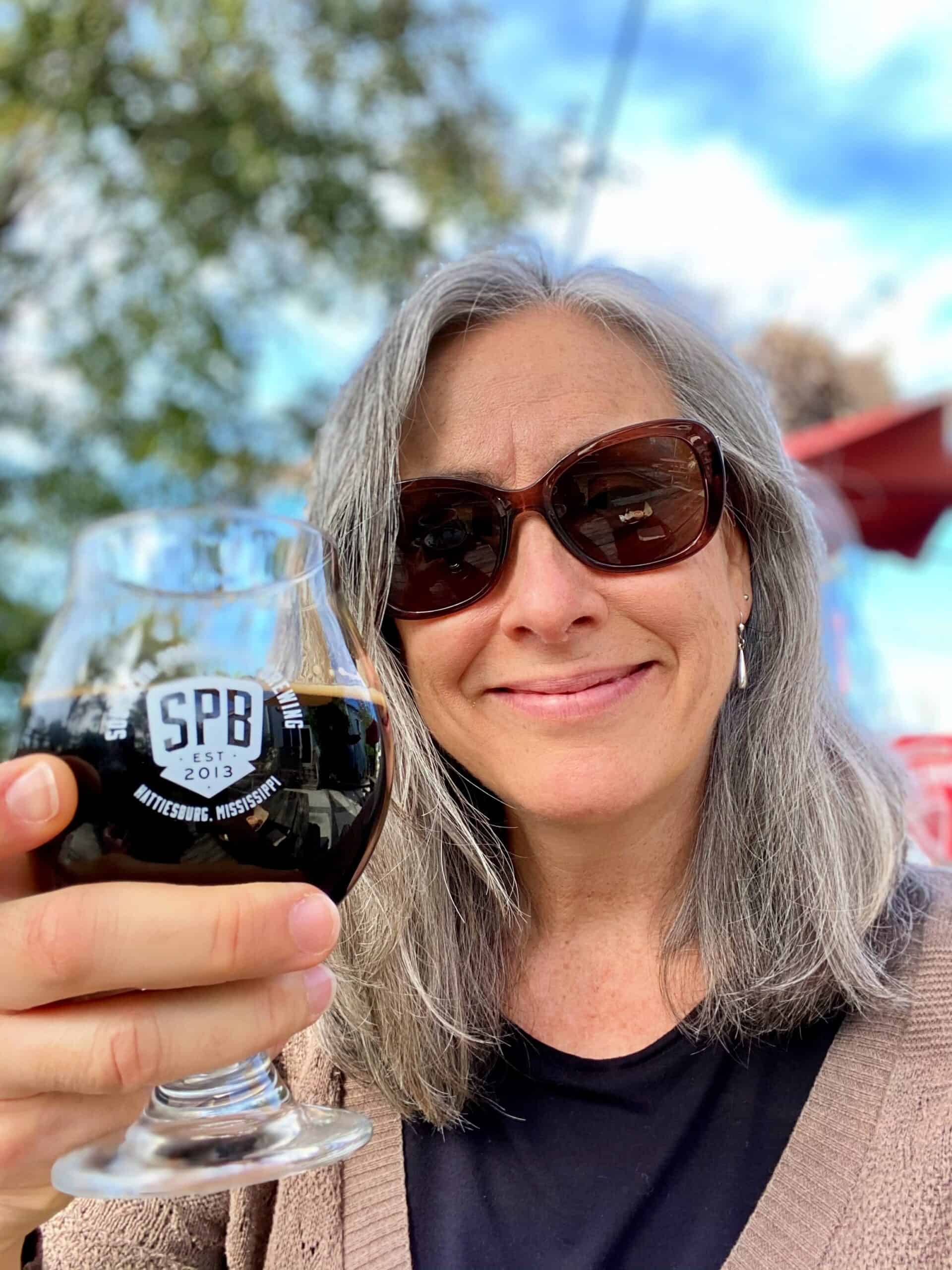Woman holding a glass of Oreo beer.