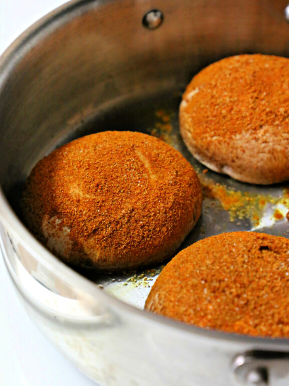 seasoned portabellas in a stainless steel skillet