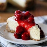 Slice of cheesecake topped with cherries.