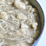 Blue pot filled with chicken and dumplings.