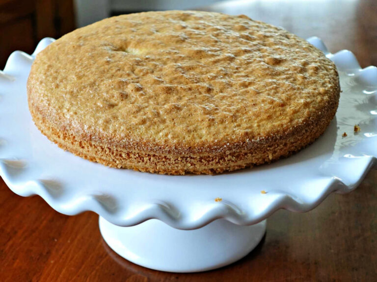 Strawberry Almond Flour Cake plain almond flour cake on a pedestal