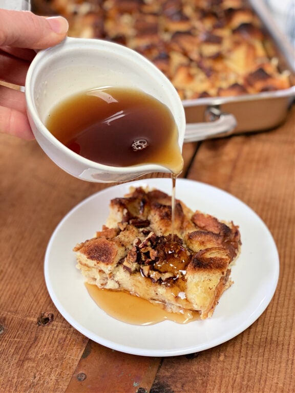 Syrup being poured on top of French toast casserole