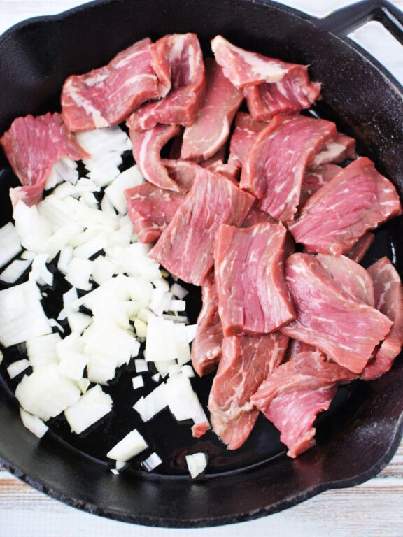 Easy Beef Stroganoff with Mushroom is quick 30 minute and under meal with big homemade flavors #beef #easydinner #recipe beef and onion in a skillet