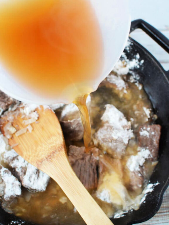 Easy Beef Stroganoff with Mushroom is quick 30 minute and under meal with big homemade flavors #beef #easydinner #recipe pouring beef broth