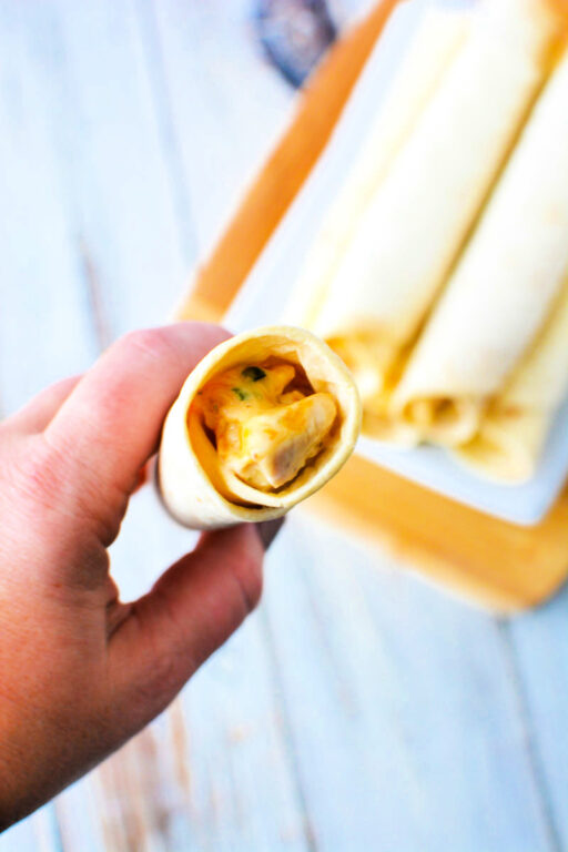 Oven Baked Chicken Taquitos with creamy chicken and cheese filling for a Mexican Appetizer everyone will love #Mexican #appetizer #sidedish #recipe viewing the inside of a taquito