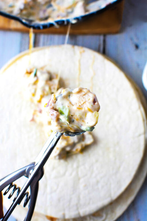 Oven Baked Chicken Taquitos with creamy chicken and cheese filling for a Mexican Appetizer everyone will love #Mexican #appetizer #sidedish #recipe scoop of taquito filling