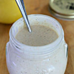 Jar of Alabama White Sauce with spoon in it.