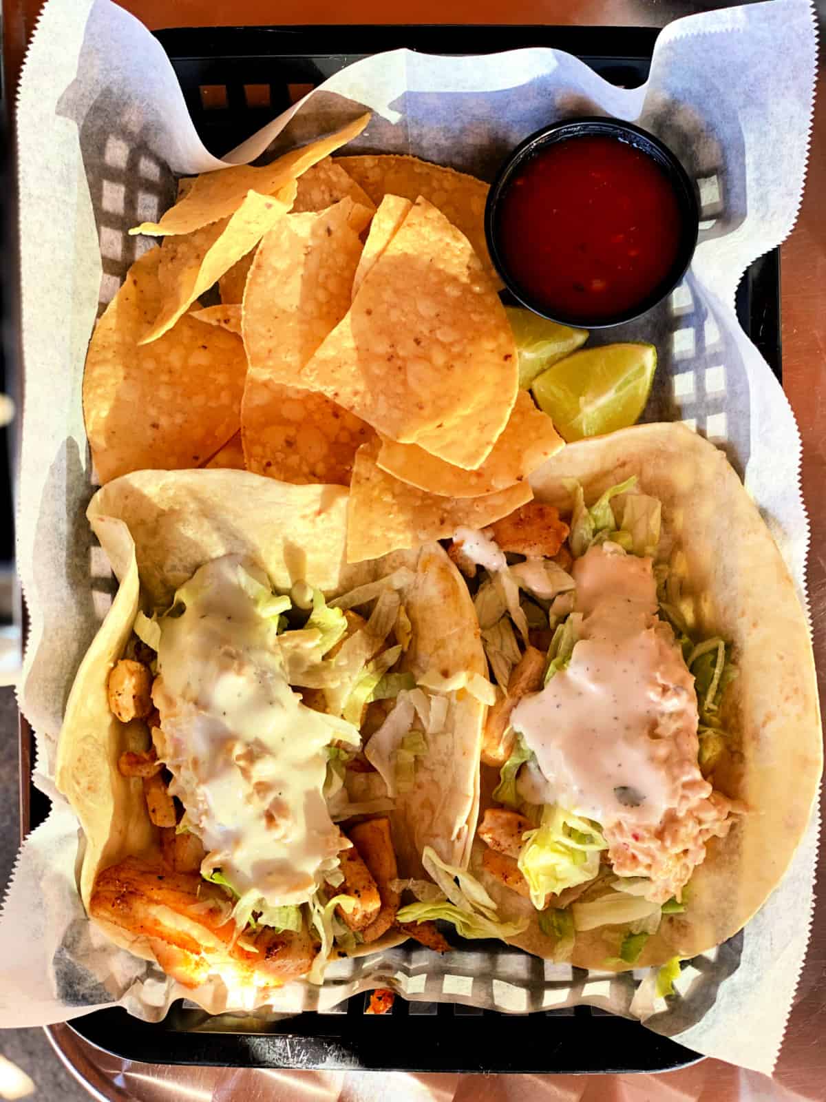 Basket of Baja fish tacos and tortilla chips.