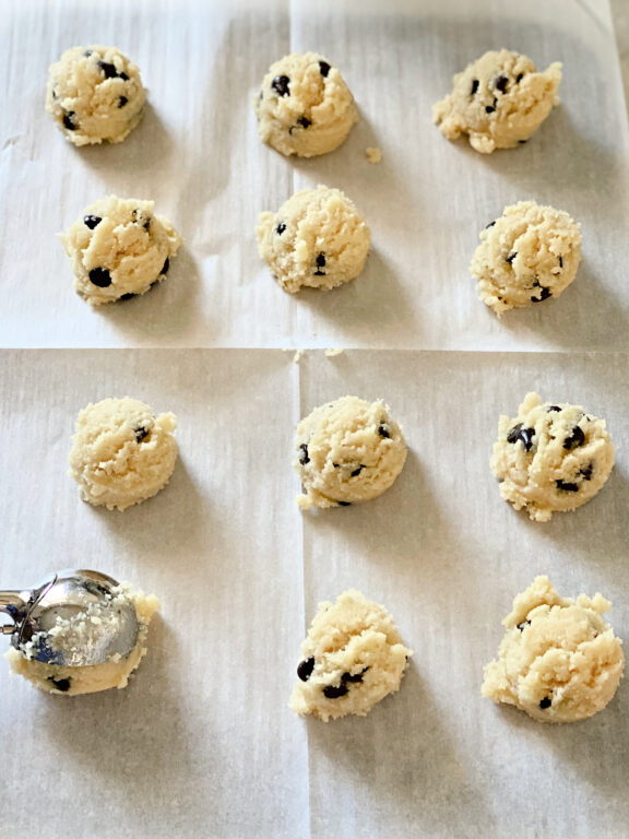 placing scoops of cookie dough on a baking sheet