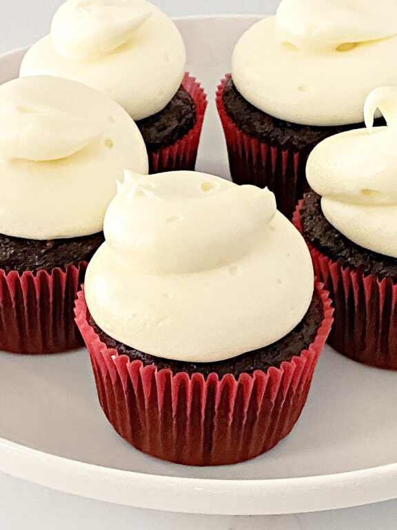 cupcakes with cream cheese frosting on a plate
