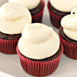 chocolate cupcakes decorated with cream cheese frosting on a plate