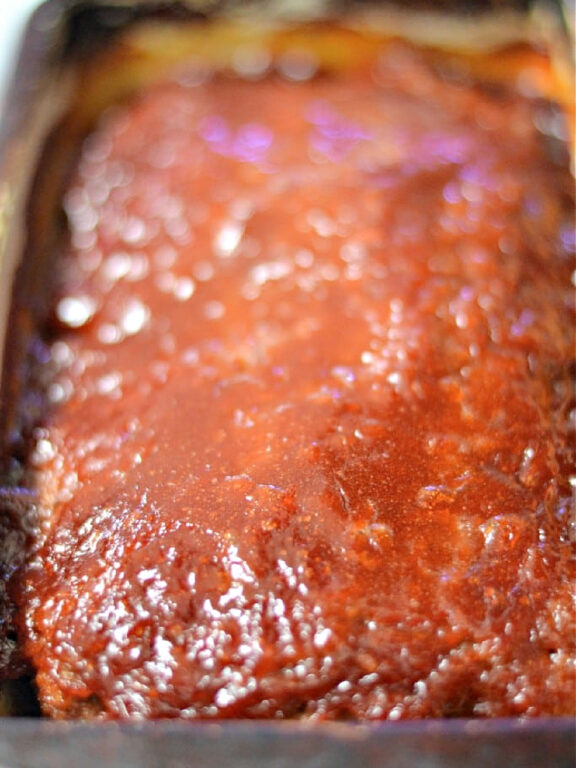 Brown Sugar Glazed Meatloaf - this recipe will soon become your family's favorite recipe for meatloaf. It's delicious! #brownsugar #meatloaf brown sugar glazed meatloaf in a pan