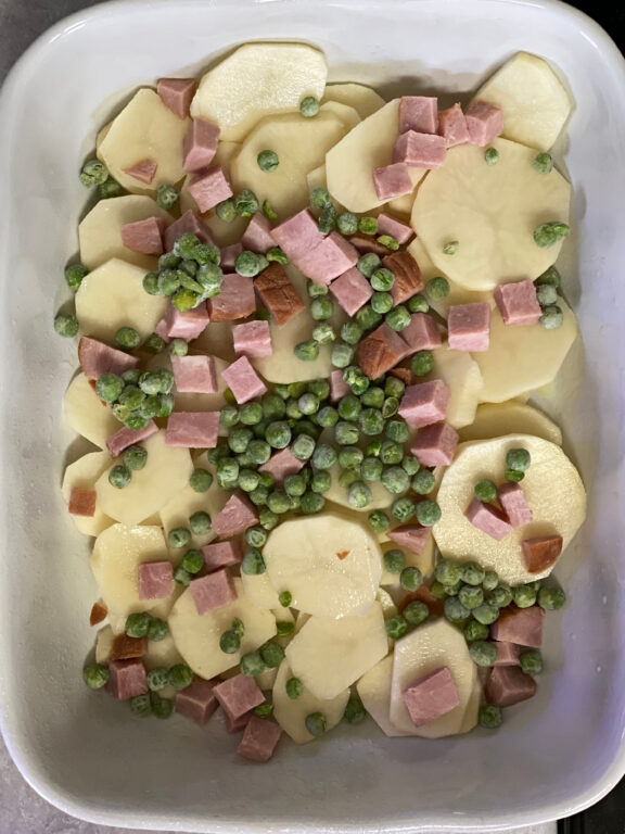 layer of ham, peas, and potatoes